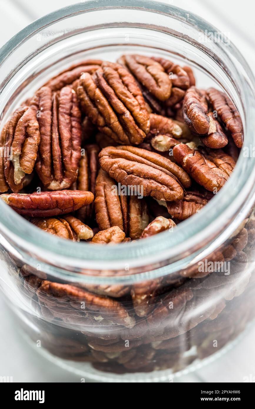 Peeled pecan nuts in jar. Stock Photo