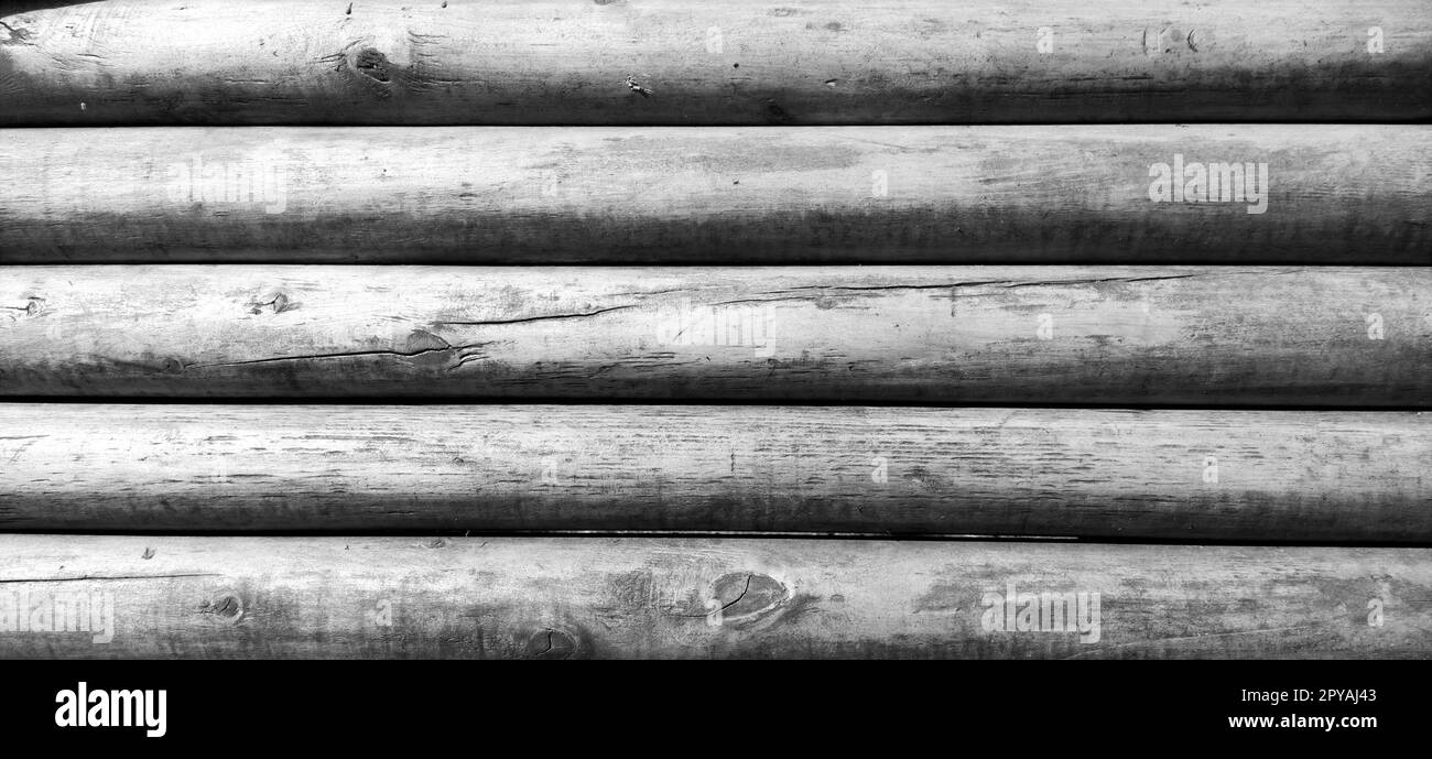 The wooden background is part of a log cabin. Wood texture. Monochrome image, black and white. Stock Photo