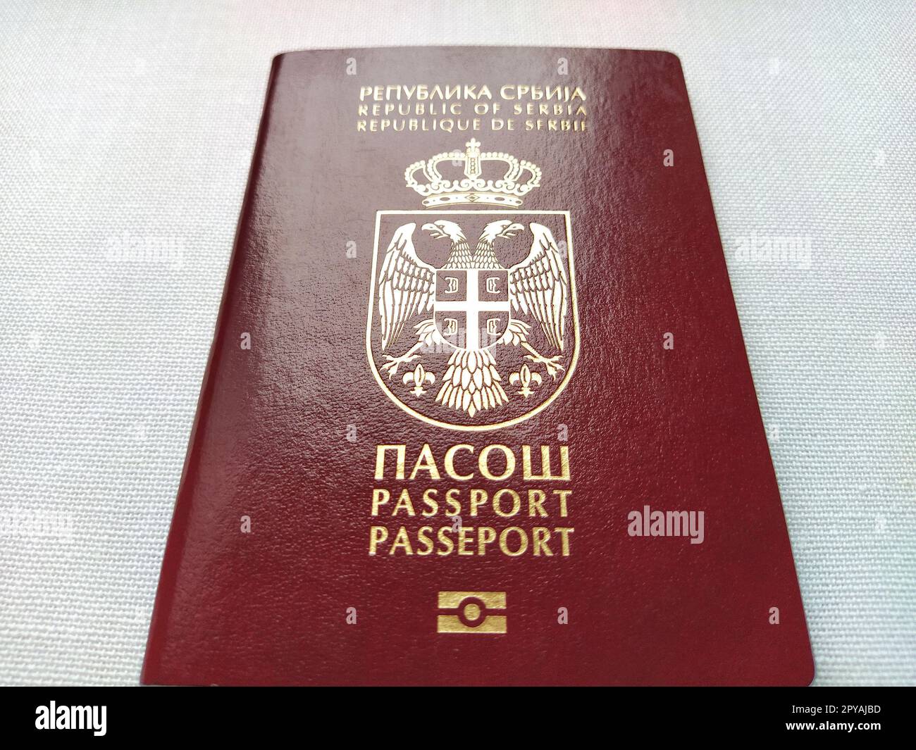 Belgrade, Serbia, November 29, 2020. Serbian passport. New biometric document for border crossing. Official documentation. Shiny letters. Black and white monochrome photography. Stock Photo