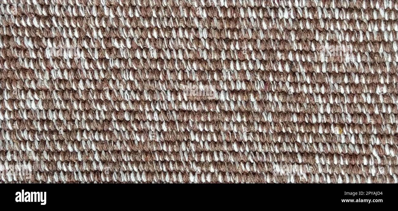 close up of fabric texture for background. Woven coarse cotton fabric with white, beige and brown threads. Banner Stock Photo