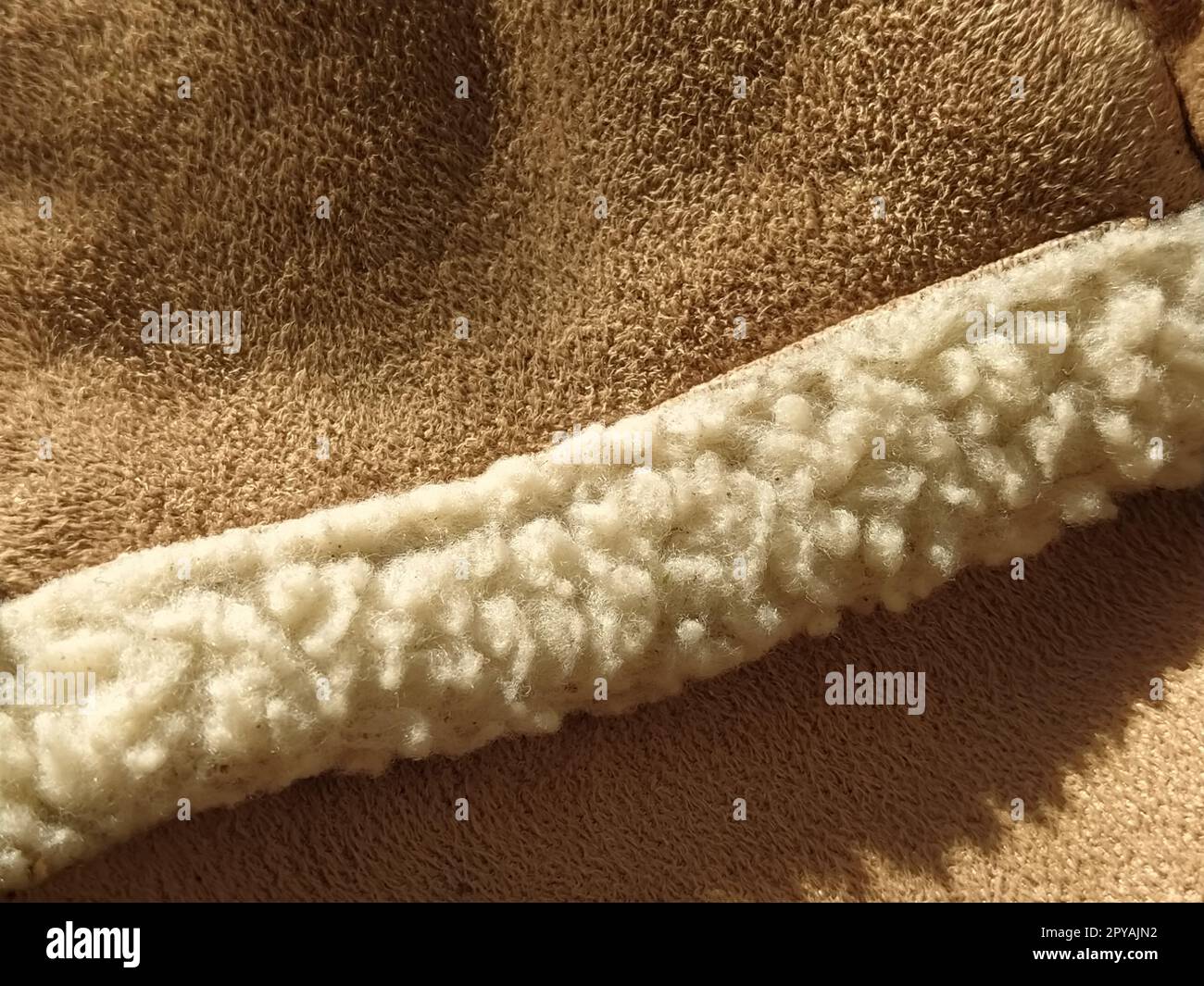 sheep fur on a suede natural product. Fur edge on winter clothes. close-up. macro photo Stock Photo