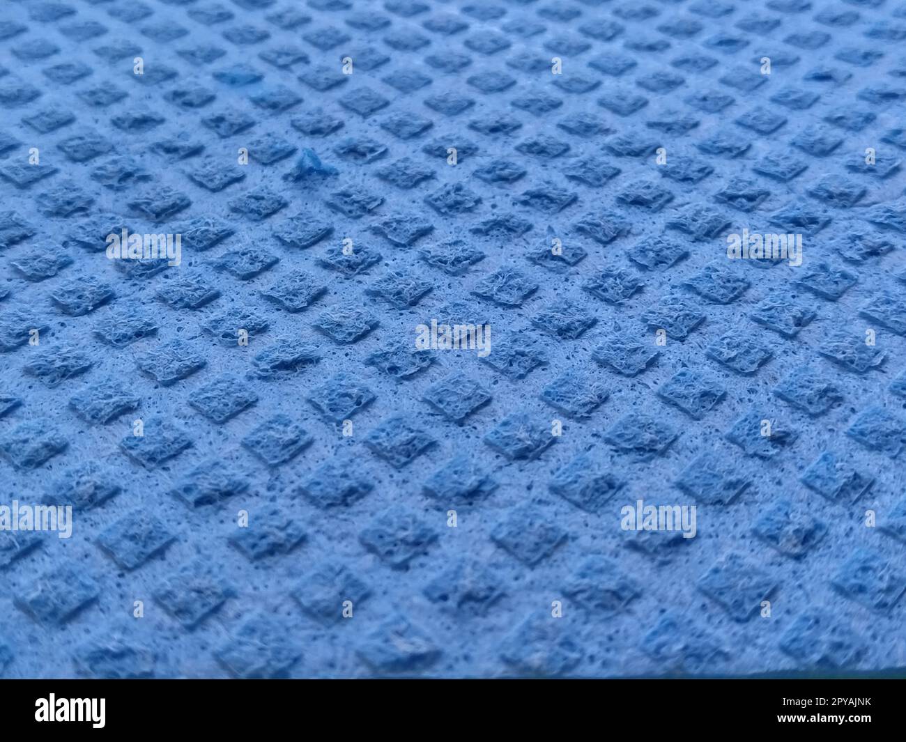 blue sponge for washing dishes, closeup. Abstract blue background