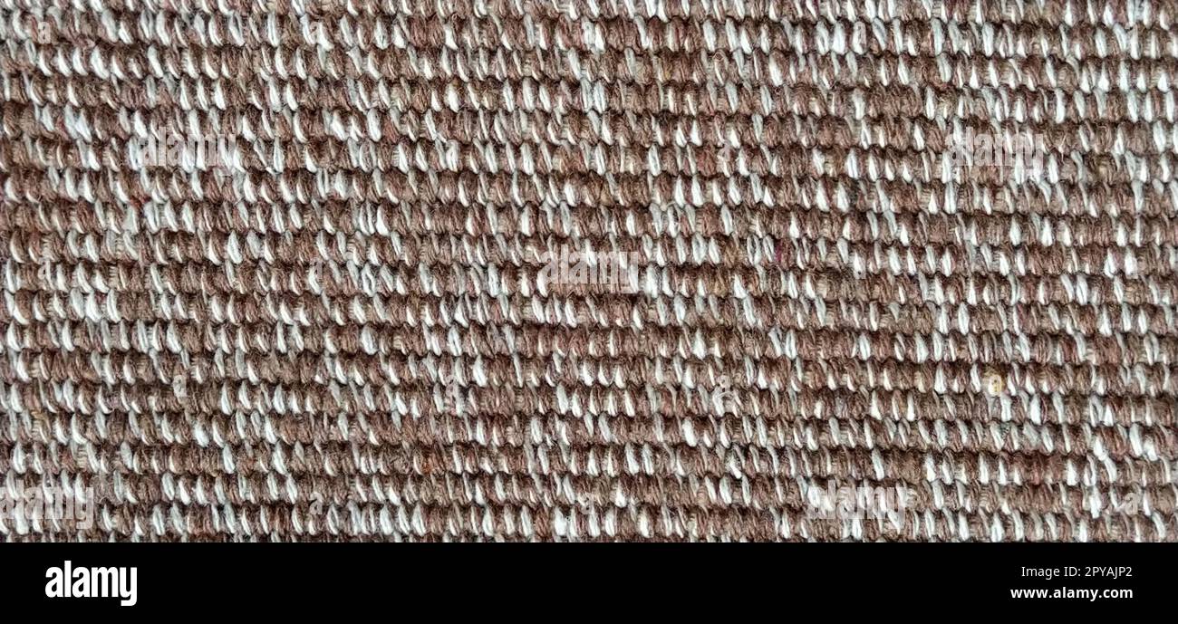 close up of fabric texture for background. Woven coarse cotton fabric with white, beige and brown threads. Banner. Stock Photo