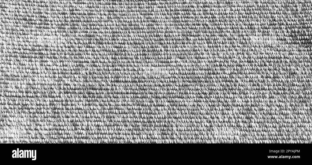 Woven coarse cotton fabric. Close-up. Black and white photography. Banner. Weaving thick threads. Smooth neat texture for the background Stock Photo