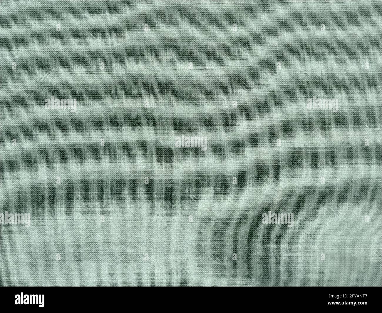 pale light green fabric. A piece of woolen fabric laid out neatly on the surface. Interlacing and textile texture. dress fabric or for kitchen needs, tablecloth or curtains Stock Photo