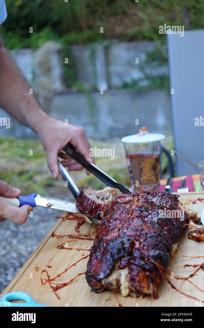 Roast is cut with a knife Stock Photo Alamy