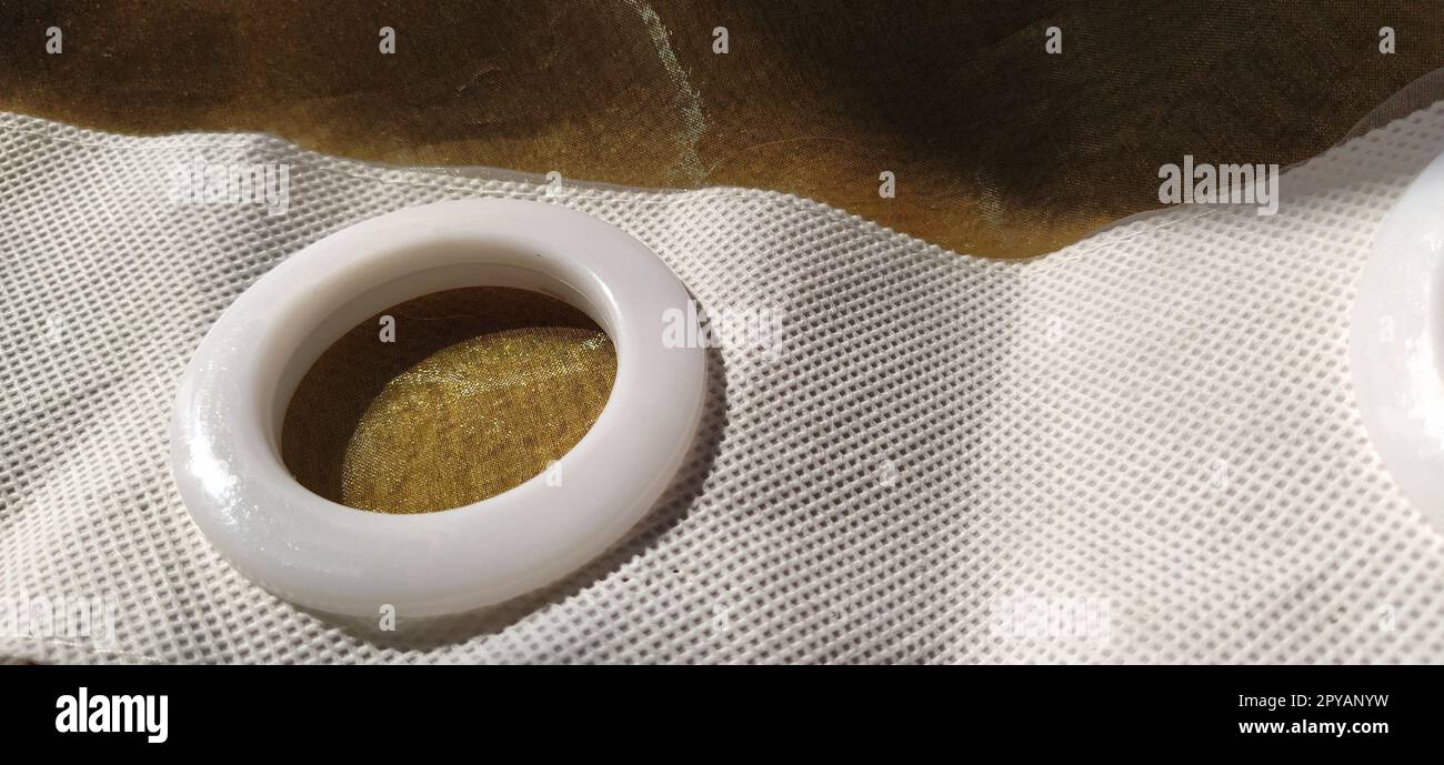 Plastic rings for attaching the fabric to the curtain rod. White