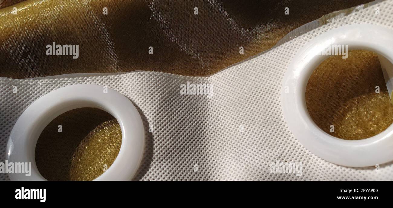 Plastic rings for attaching the fabric to the curtain rod. White