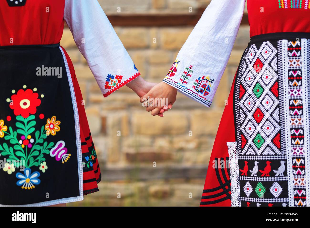 Girls in traditional bulgarian ethnic costumes with folklore embroidery