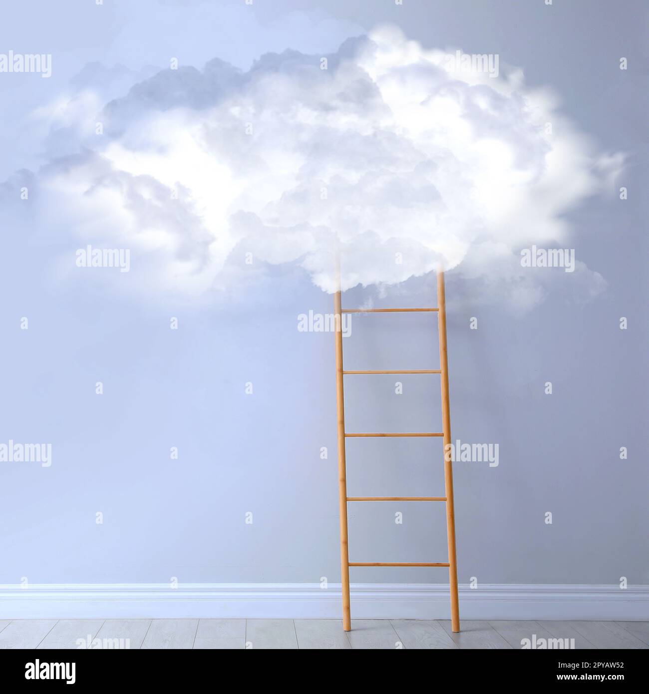 Wooden ladder leading to white cloud on light blue wall in room ...