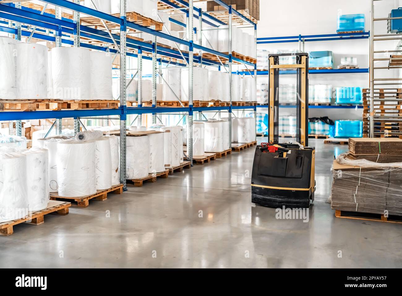 racks with plastic packaging in the warehouse. forklift truck Stock Photo