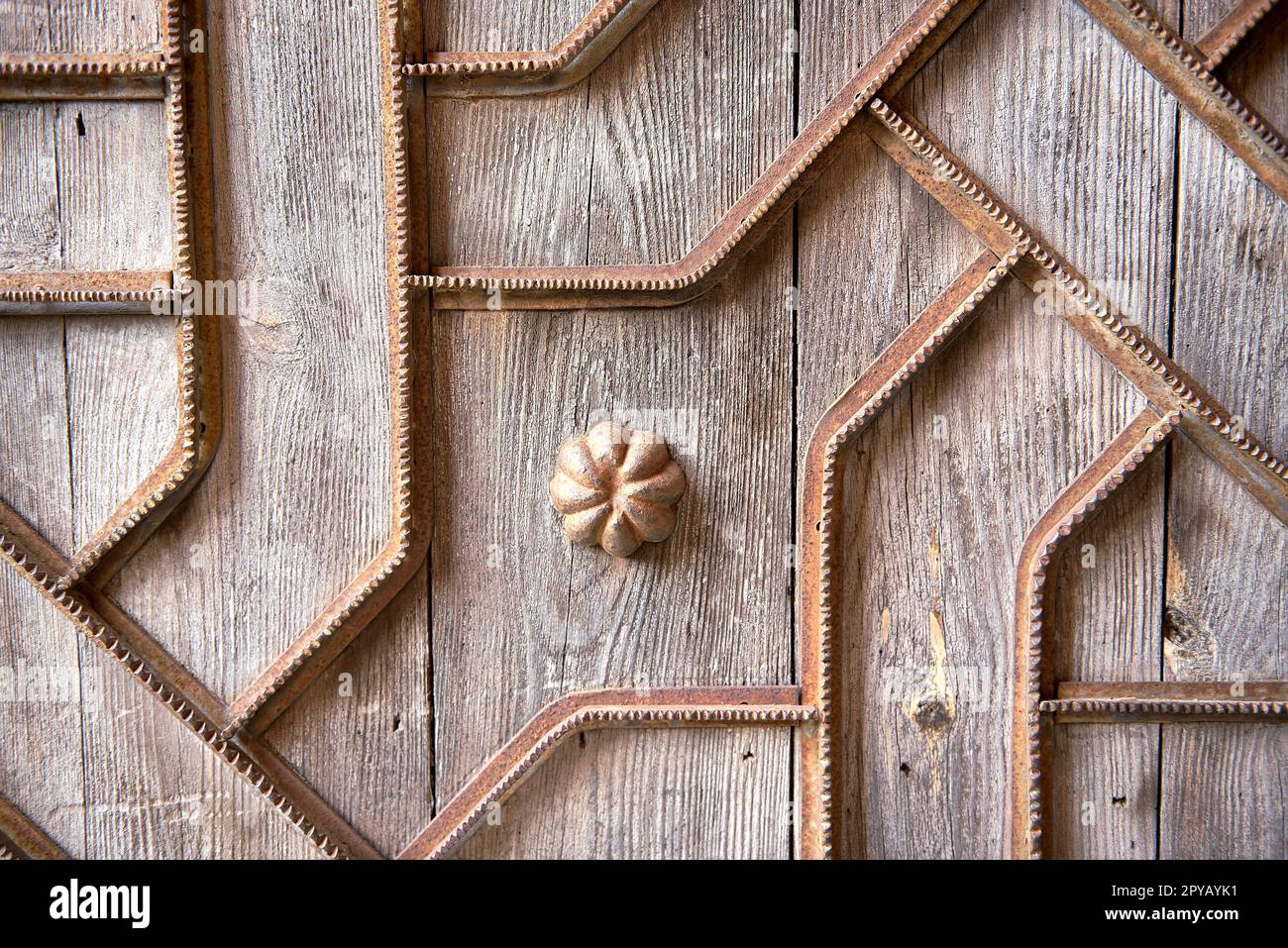 Detail of wooden door with metal ornaments Stock Photo