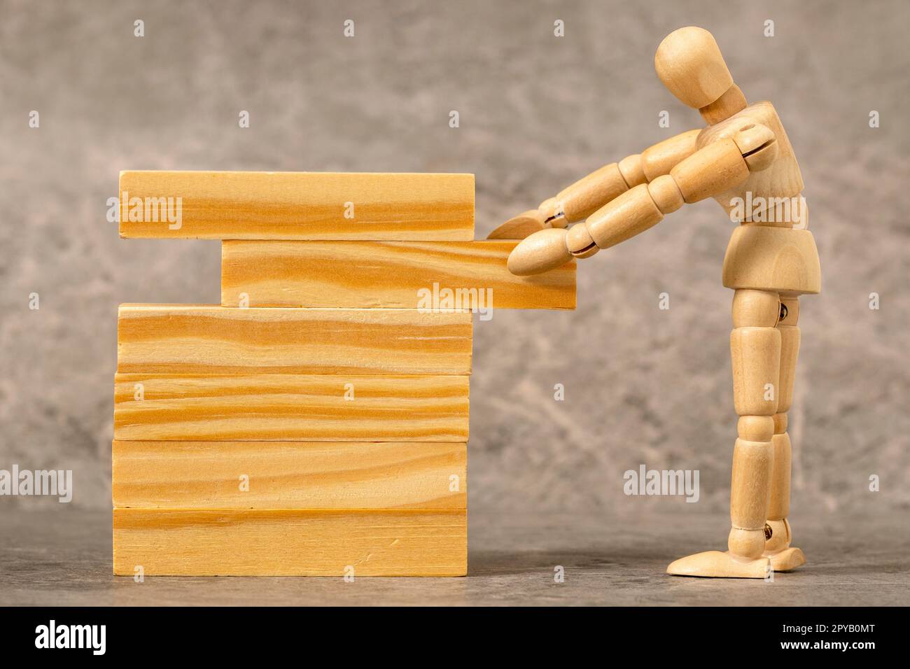 Dummy pulling out wood block from a tower, plan and strategy in