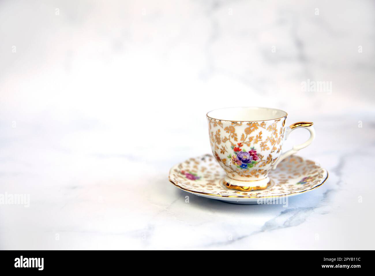 Antique porcelain tea cup on white background copy space. traditional English vintage ceramics Stock Photo
