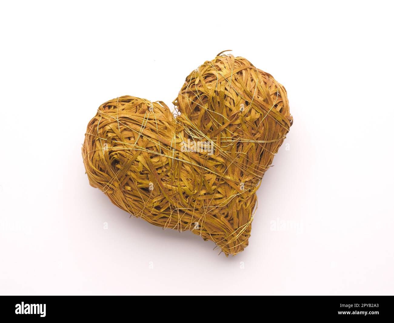 Close up of a green straw heart shape on a white background Stock Photo