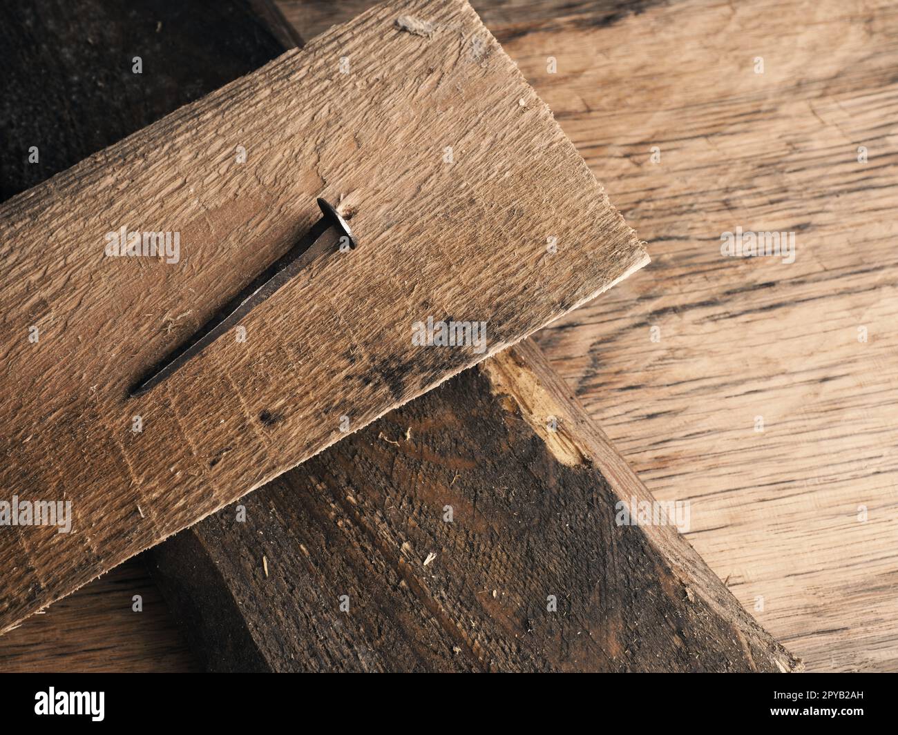 Wooden cross with an old rusty nail symbolizes the crucifixion of Jesus
