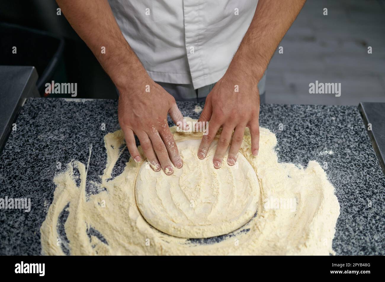 Midsection of man chef preparing food at professional kitchen Stock Photo