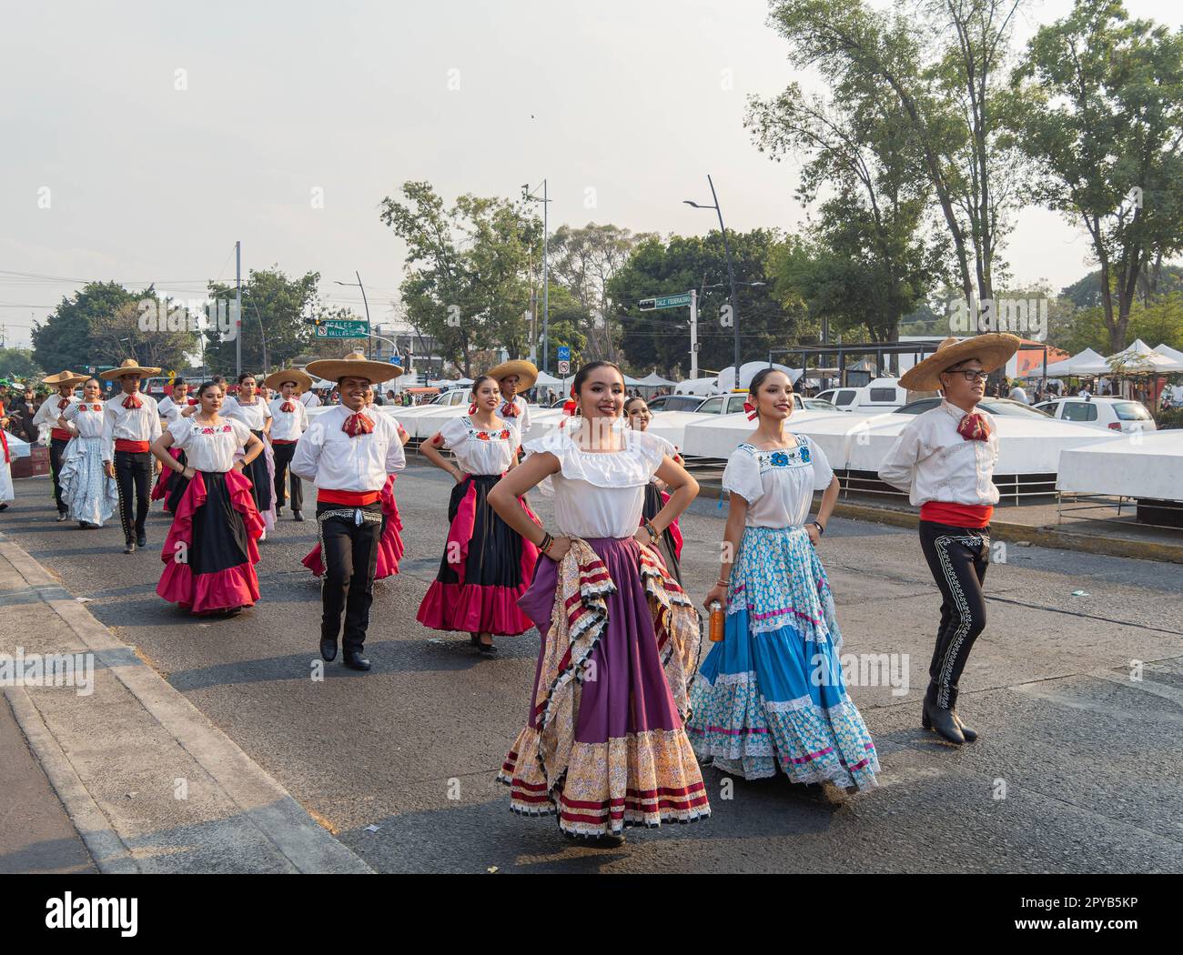 Mexico, APR 22 2023 - People dress up in traditional clothes parade in the street Stock Photo