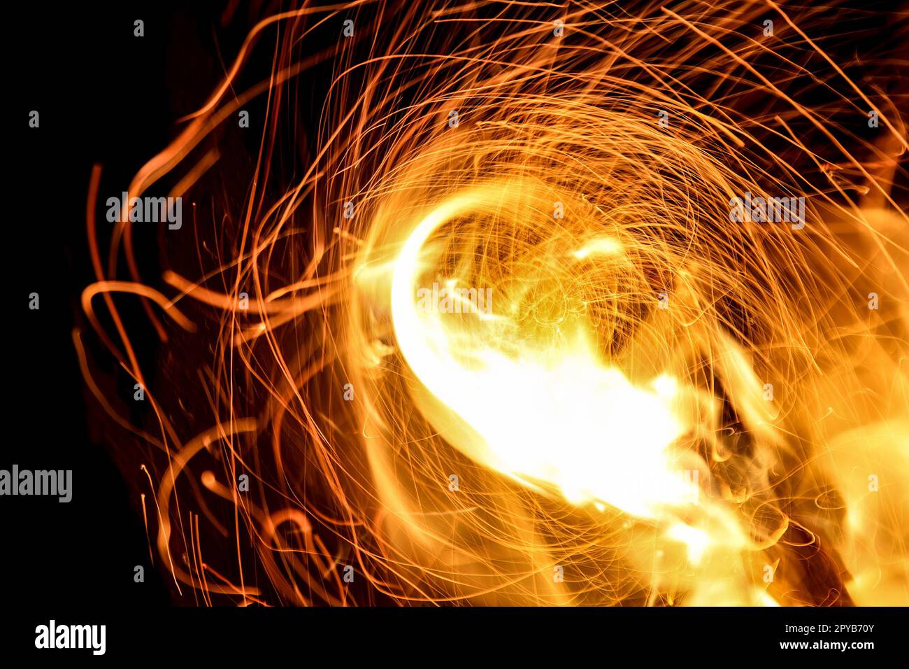 Fire with swirls of sparks in the night Stock Photo