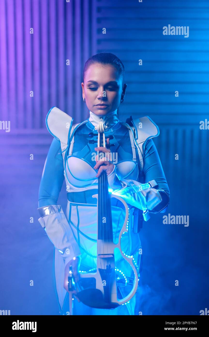 Beautiful young woman posing with original electric violin Stock Photo Alamy