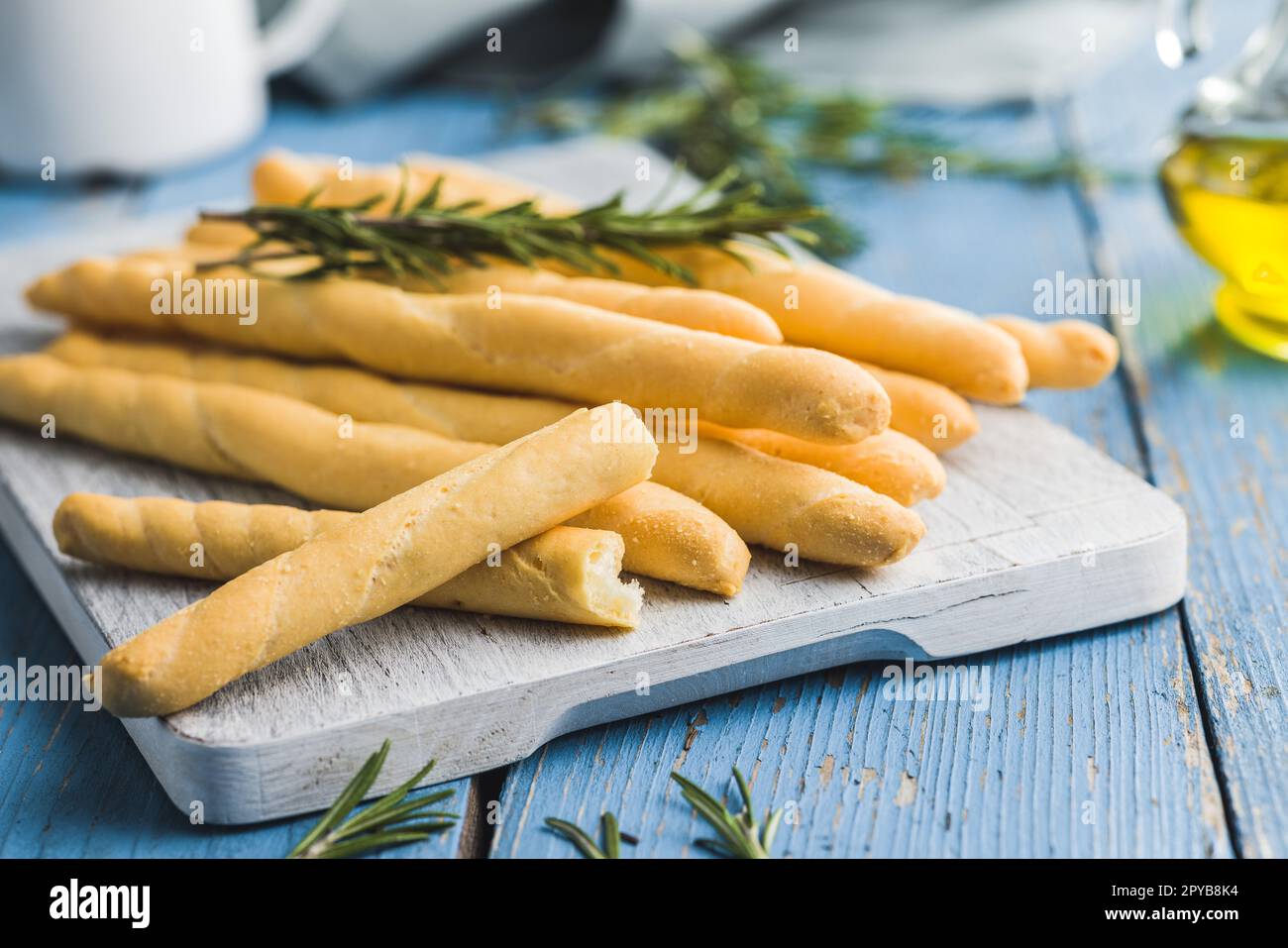 Italian grissini bread sticks on blue table. Stock Photo