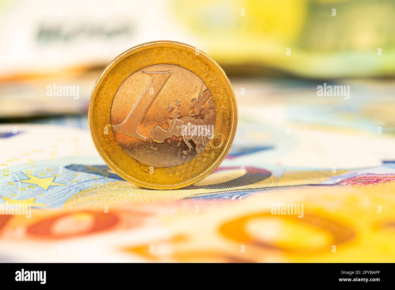 One euro coin on the bills of euro banknotes Stock Photo