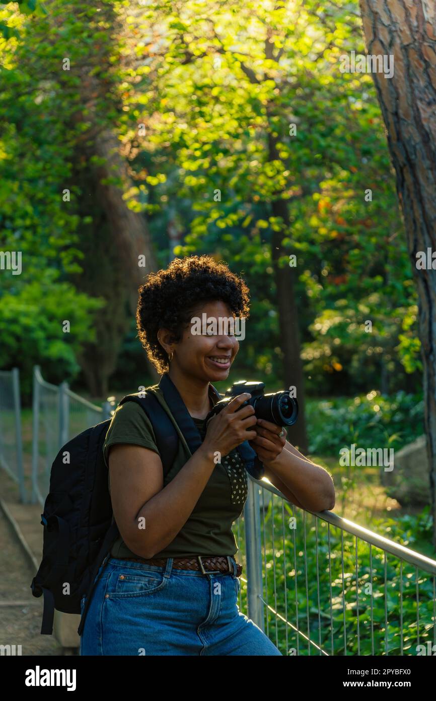 Young black African American female photojournalist with dark curly
