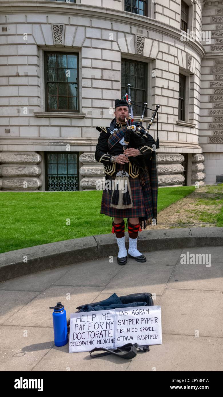 Canadian Piper playing traditional bagpipes, Westminster, London UK 30th April 2023 Stock Photo