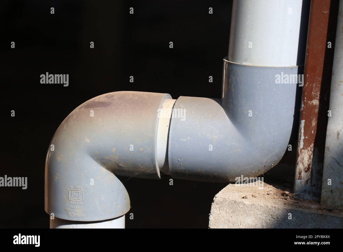 The joins of a PVC pipe used in plumbing to carry water from the roof