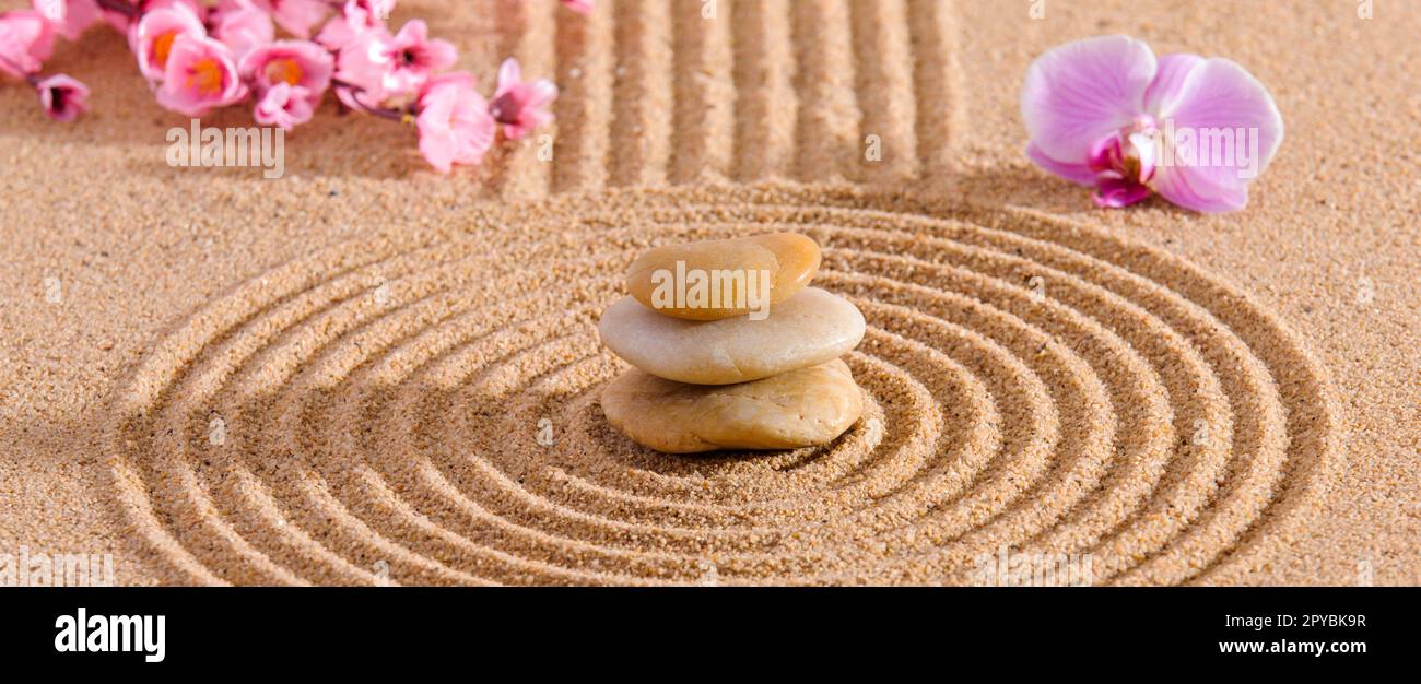 Japanese Zen garden with stone in textured sand Stock Photo
