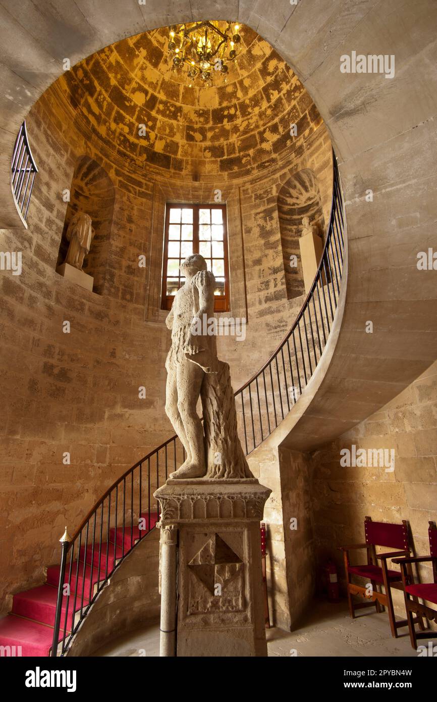 Spiral elliptical staircase ,19th century, and statue of the navigator Jaume Ferrer. Consolat de Mar, (seat for the presidency of the Balearic Governm Stock Photo