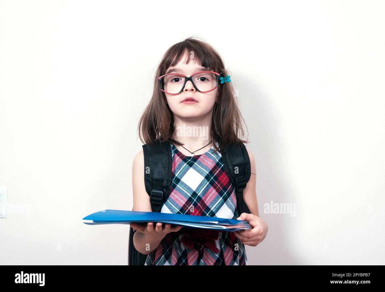 Little girl reading a book at home Stock Photo - Alamy