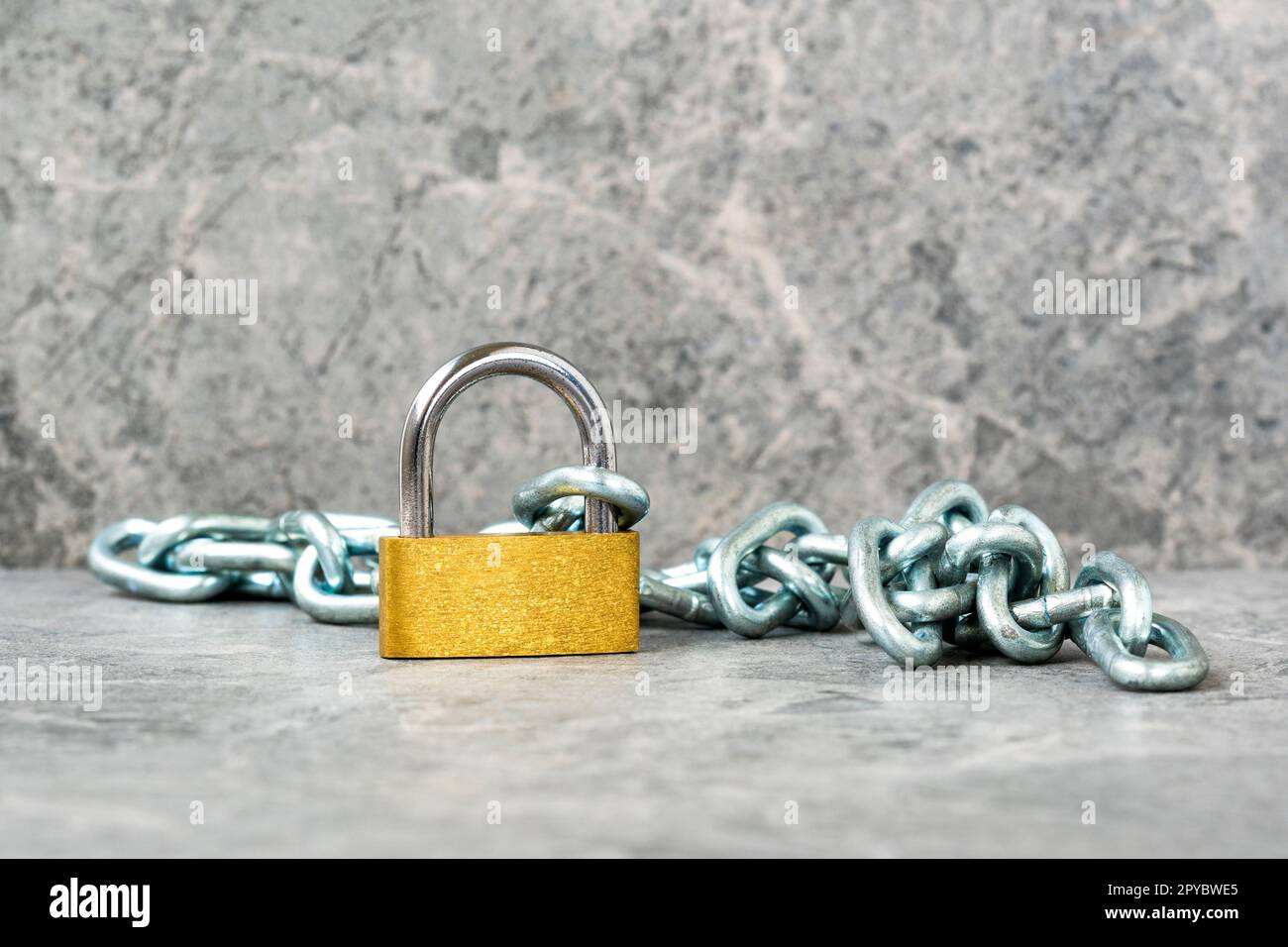 Yellow padlock with a steel metal chain Stock Photo