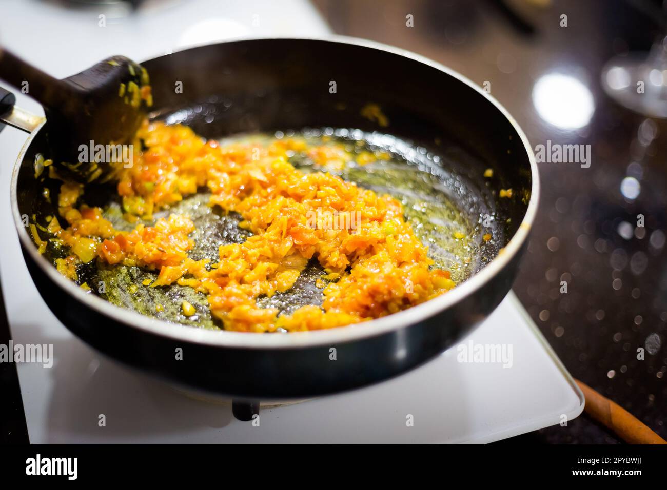 Traditional way of preparing indian food mushroom curry using gas pan
