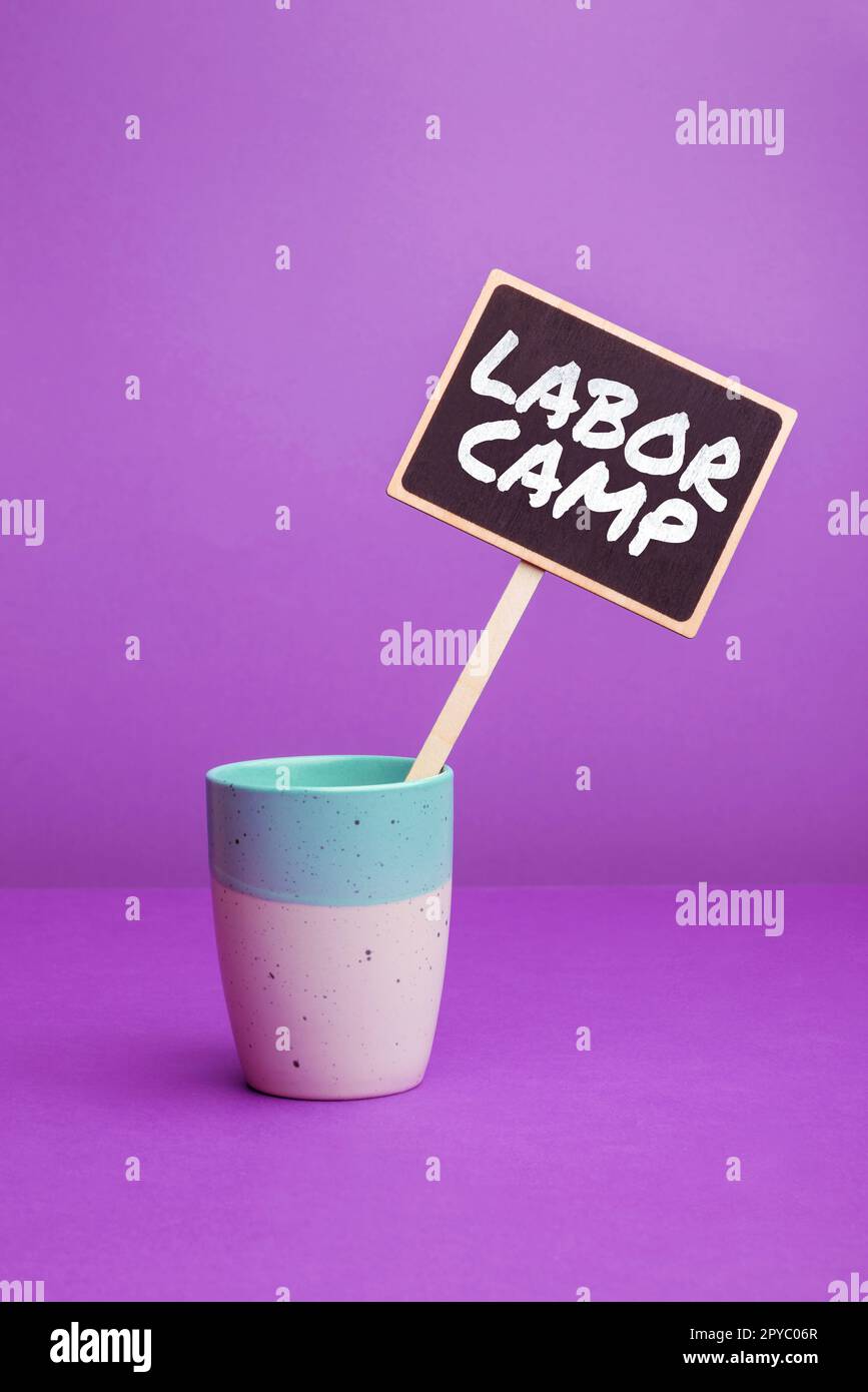 Sign displaying Labor Camp. Word for a penal colony where forced labor is performed Stock Photo