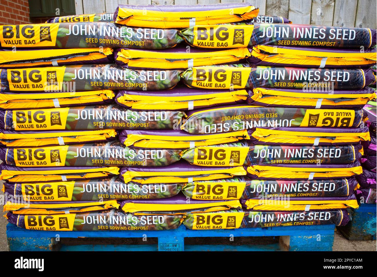 A stack of  35 litre big value bags of John Innes seed sowing compost for sale in a farm shop Stock Photo