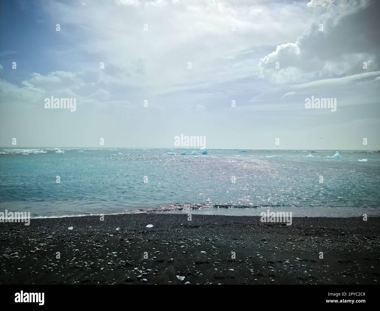 Diamond Beach in Iceland with blue icebergs melting on black sand and