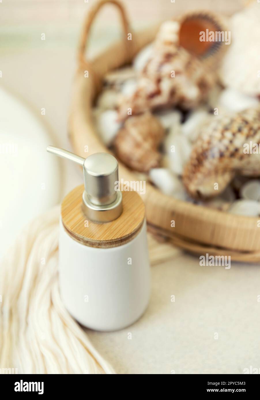 Body gel and face cream among sea stones and shells. Spa treatments. Slow travel. Stock Photo