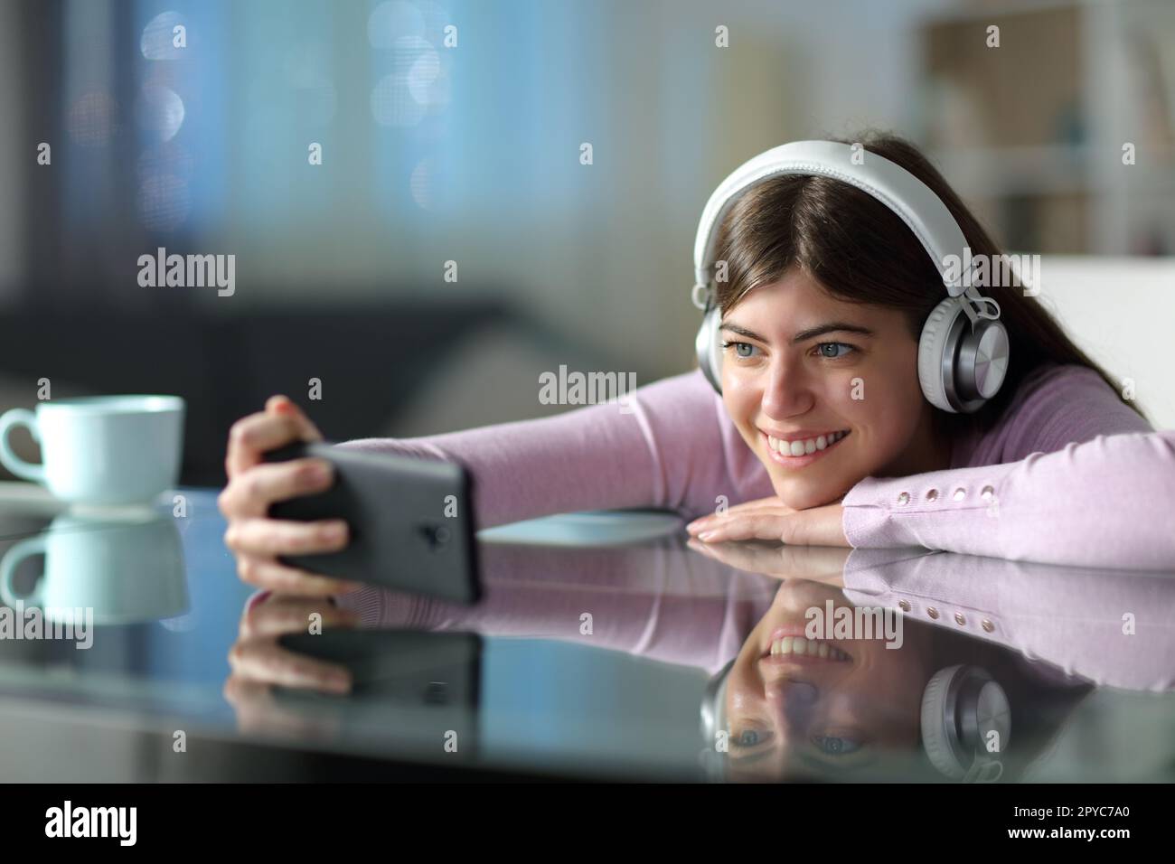 Happy teen watching media on phone in the night Stock Photo