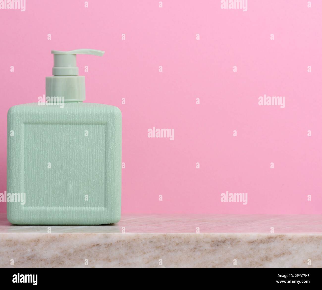Plastic soap dispenser container on a pink background, cosmetics Stock
