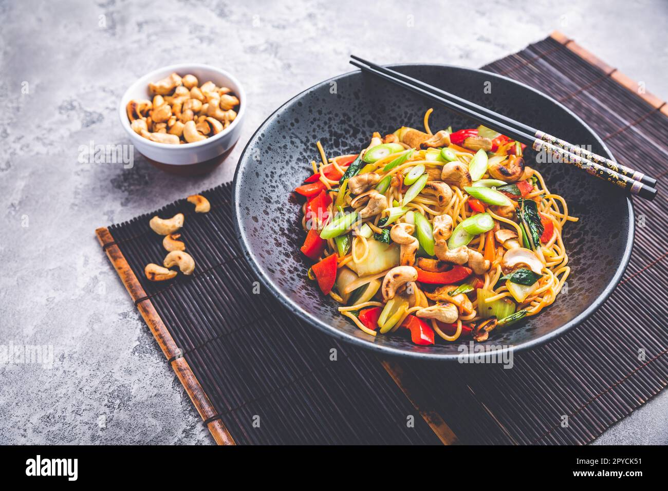Stir fry noodles with chicken, vegetables and  roasted cashew nuts Stock Photo