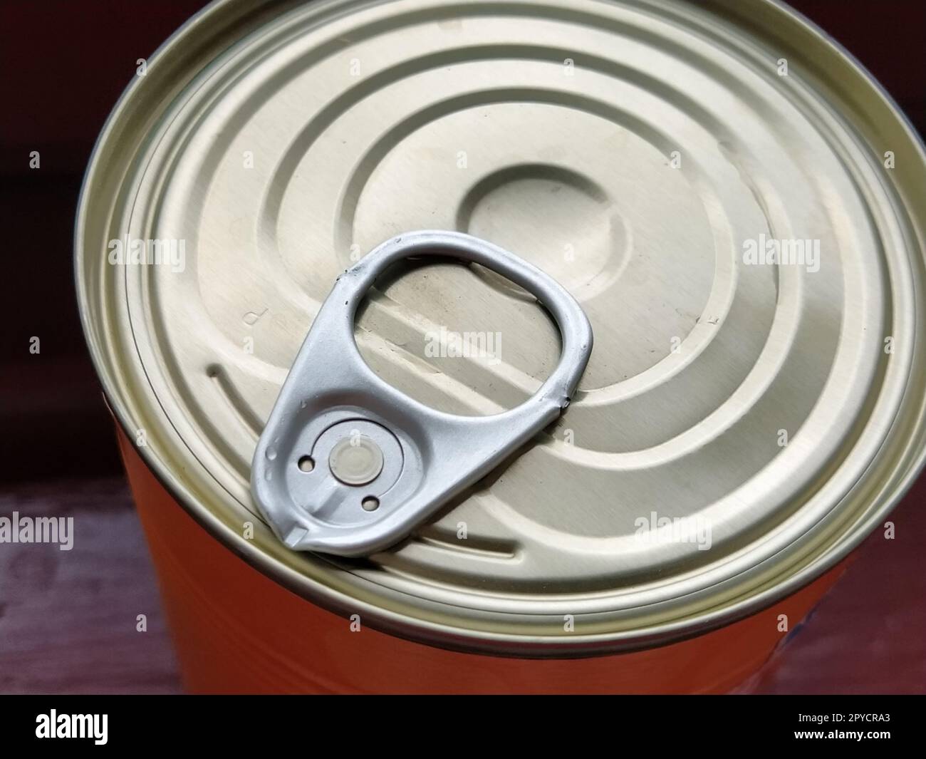 canned food lid with a bottle opener. Hook metal can top for easy opening Stock Photo