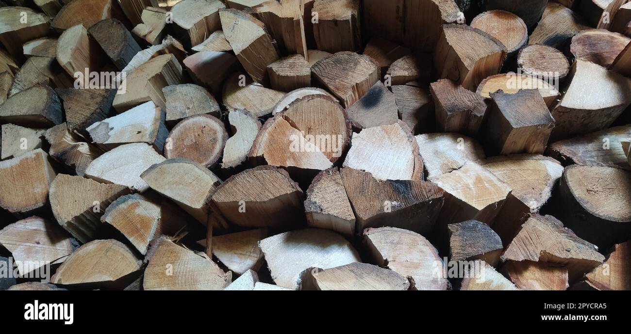 logs of wood in a pile ready to be cut and chopped for firewood in a  fireplace and boiler Stock Photo - Alamy