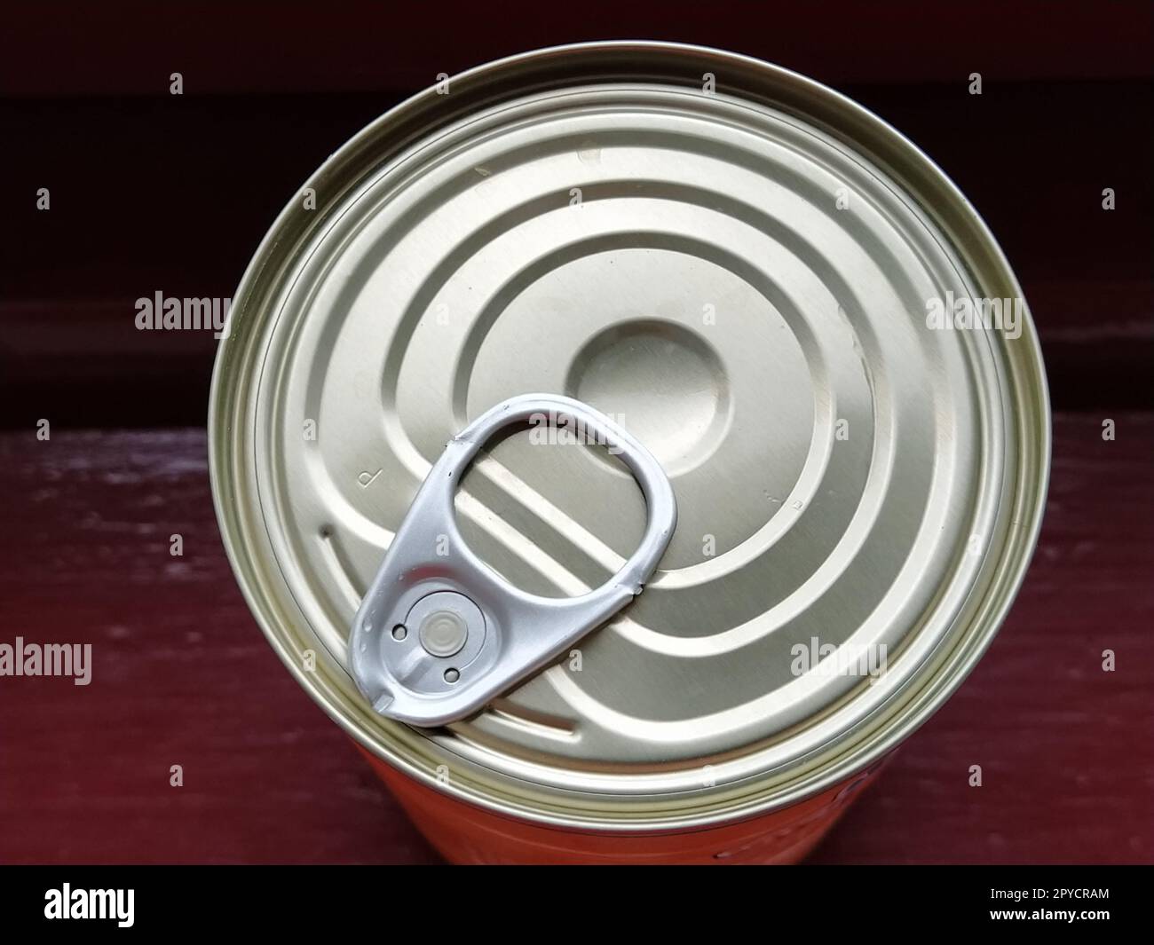 canned food lid with a bottle opener. Hook metal can top for easy opening Stock Photo
