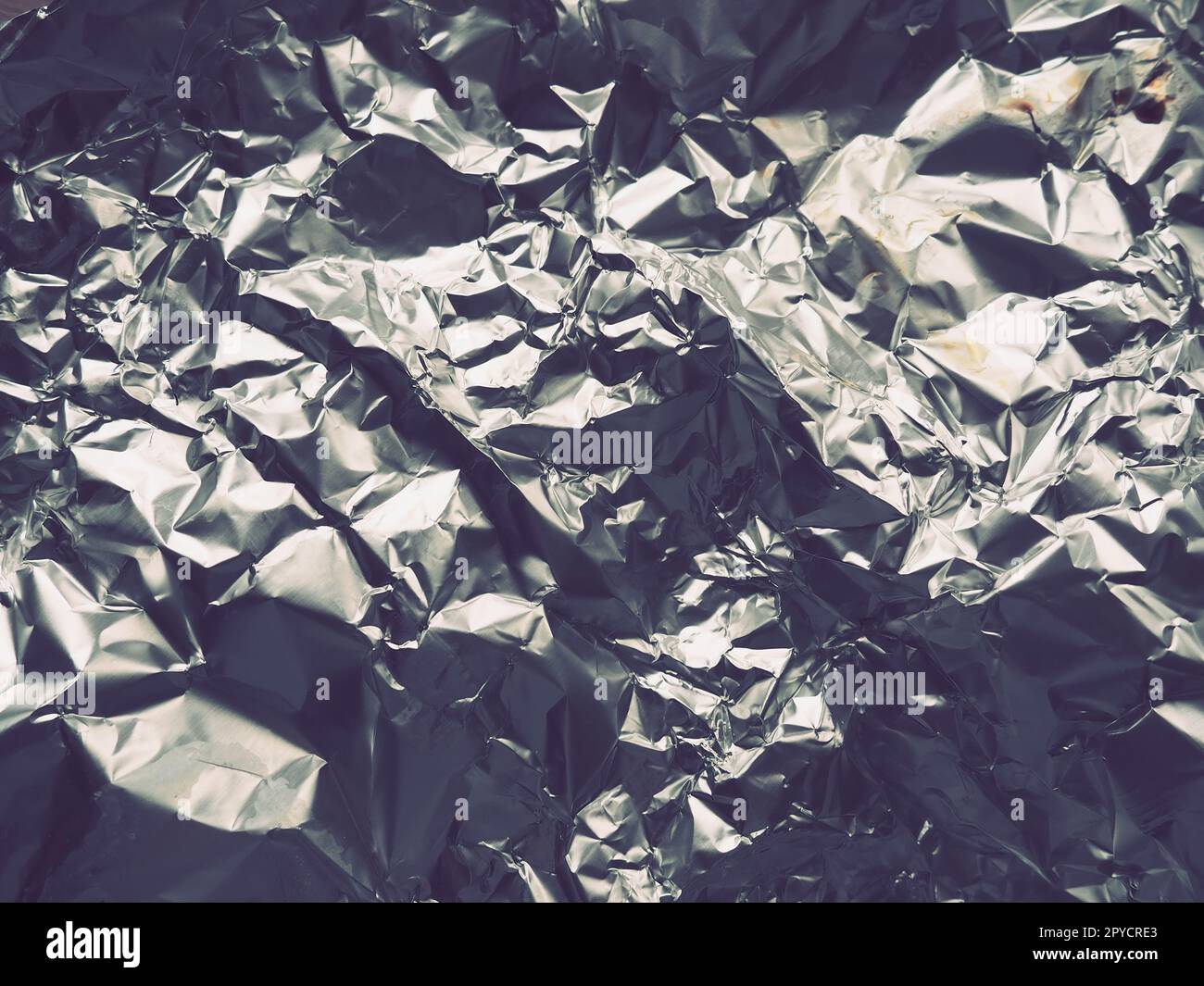 foil close-up. Aluminum silver crumpled foil. Abstract metallic background. Foil for baking food. Background Stock Photo