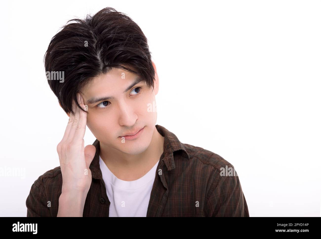 Young man standing over white background depressed and worry for distress Stock Photo