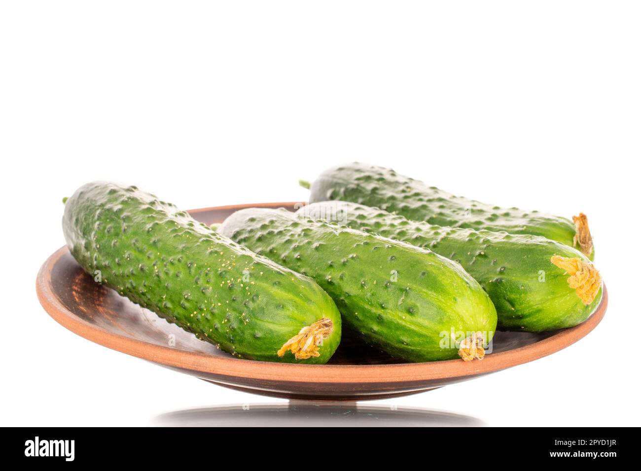 Five Ripe Green Cucumbers On A Clay Plate Macro Isolated On White