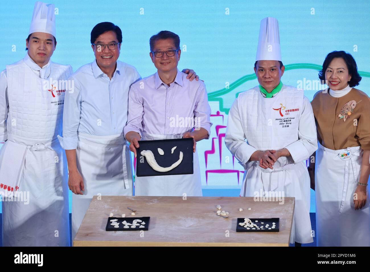 Deputy Financial Secretary Michael Wong Wai-lun (2nd left); Financial Secretary Paul Chan Mo-po (3rd left);  amd Secretary of Home and Youth Affairs Bureau Alice Mak Mei-kuen (1st right); with Chinese Culinary Institute members attending the launch ceremony of Happy Hong Kong at Grand Stair, M+, West Kowloon Cultural District.  28APR23.  SCMP/ Dickson Lee Stock Photo