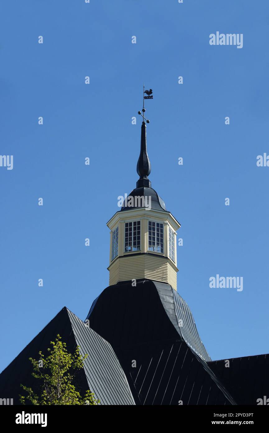 weather vane rooster on the spire of an old house Stock Photo