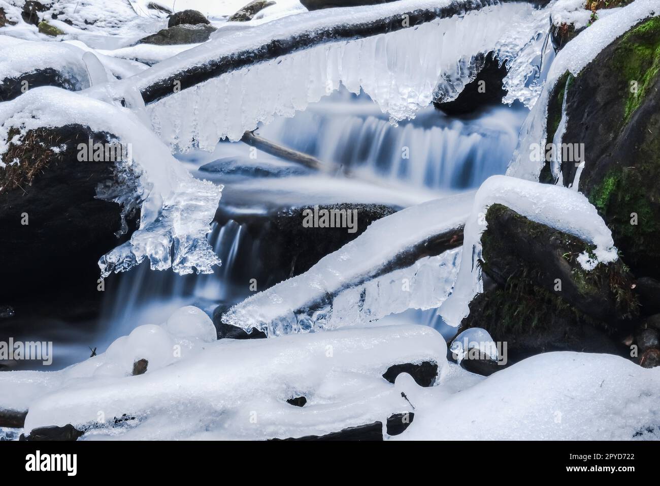 Brook Using Ice frozen branches and rocks in a brook Stock Photo - Alamy
